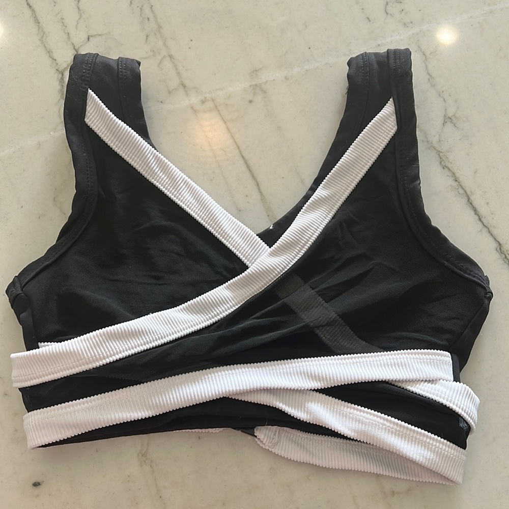 Black and white 5 dance sport bras with wrap mesh detail.